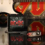 AC/DC black leather wallet with silver chain and red logo, rock-inspired collectible accessory.