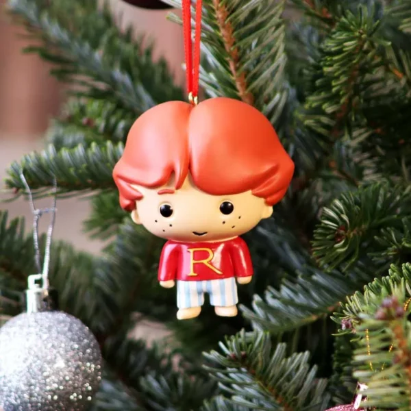 Ron Weasley Christmas Ornament Figurine - Red Sweater Design A Ron Weasley Christmas ornament hanging on a decorated green tree with a silver bauble.