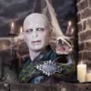 A realistic Lord Voldemort bust with a snake coiled around his shoulder and piercing blue eyes.