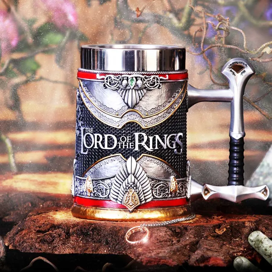 A decorative metallic AragornLord of the Rings mug with sword-shaped handle and glowing One Ring on chain.