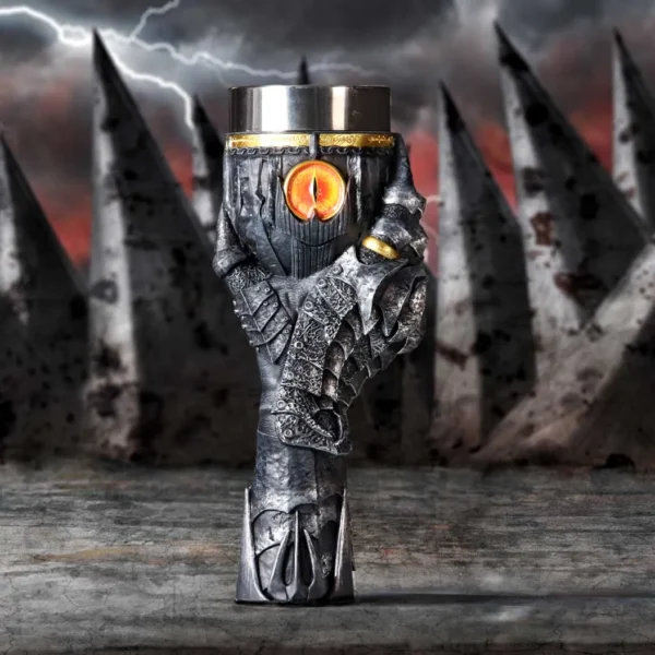 Dark Silver Gauntlet Goblet Cup - Glowing Eye and Golden Ring A metallic gauntlet-shaped goblet with a glowing orange eye and golden ring on its finger.