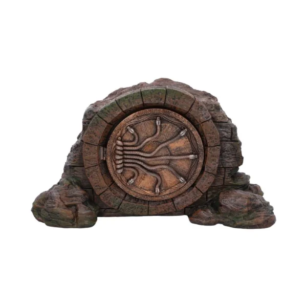 Ancient Bronze Circular Door Stone Sculpture - Moss Covered Ancient circular stone door with bronze details embedded in moss-covered rocky surface.