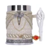 A fantasy-inspired beige and gold ornamental mug with silver accents and a jeweled white handle.