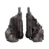 Stone King Statues Gray Cliff Sculptures - Majestic Guardians Two towering stone statues of robed kings with raised hands carved into rocky cliffs.