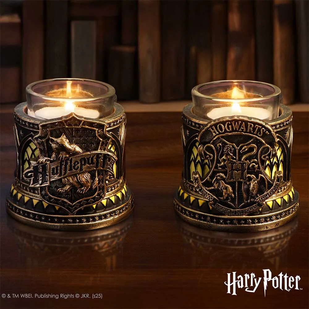 Collector Shelf - Two ornate Harry Potter candle holders with lit candles on a wooden surface.