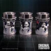 Three silver-and-white Star Wars Stormtrooper-themed cups with engraved designs on a dark reflective surface.