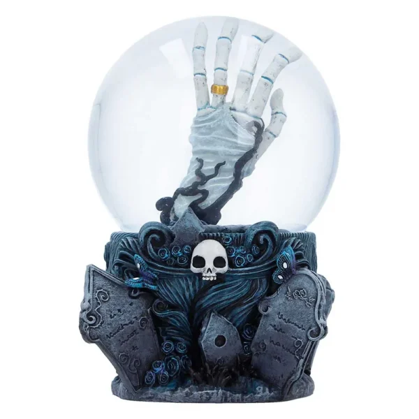 A gothic snow globe with a skeletal hand rising from a grave amid tombstones and blue roses.