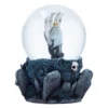 Gothic Snow Globe Resin Ornament Black - Skeletal Hand Rising A gothic snow globe with a skeletal hand rising from a graveyard base adorned with skulls and roses.