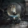 A gothic Corpse Bride snow globe with a skeletal hand, gravestones, and blue roses.