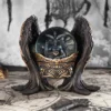 Gothic black and gold Baphomet crystal ball ornament with winged base and mystical design.