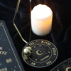 Brass Pendulum Divination Board Black Gold - Celestial Design Black and gold celestial pendulum divination board with candle for spiritual readings.