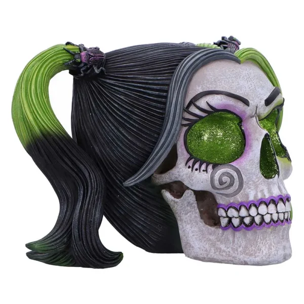 Green-Eyed Resin Skull Decor - Black Hair With Purple Detail White resin skull with green glitter eyes, black and green ponytails, and purple gothic details.
