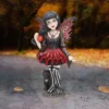 Gothic Fairy Figurine Resin Statue Red Black Wings With Cat A gothic fairy figurine with red and black wings holding a glowing apple beside a black cat.