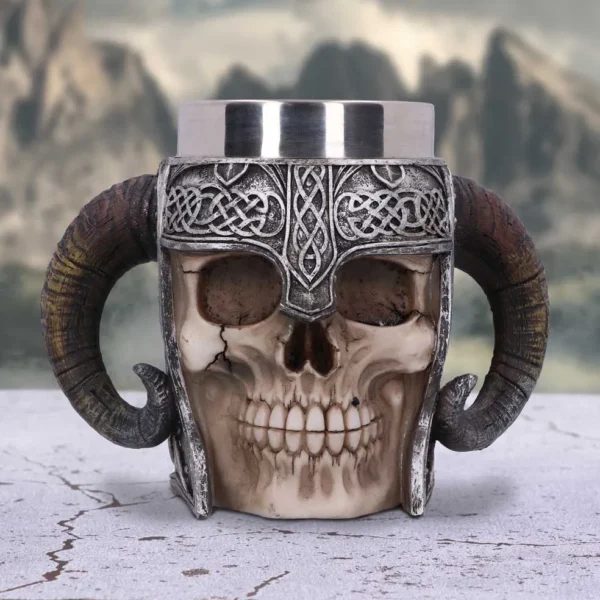 Viking Skull Mug Stainless Steel Brown Ram Horn Design A Viking skull mug with ram horns and metallic helmet on a stone surface.