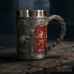 A detailed metal Game of Thrones mug featuring House Stark and House Lannister emblems.