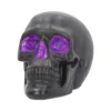 Black Skull Sculpture Resin Art - Glittery Purple Eyes A matte black human skull sculpture with glittery purple resin filling the eyes and nose.