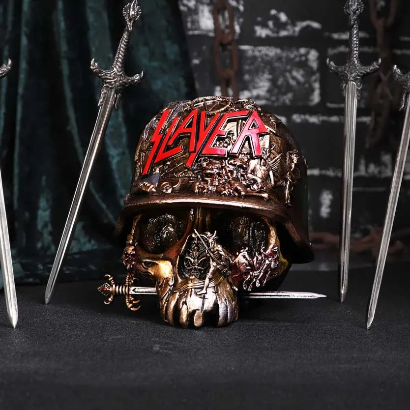 Bronze skull sculpture with Slayer helmet, crossed swords, and dark metal-themed background.