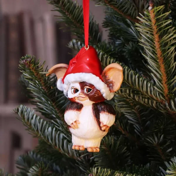 Gizmo Christmas Ornament Figurine Red Santa Hat - Festive Charm Gizmo Christmas ornament with Santa hat hanging on a green Christmas tree branch The-Hidden-Hatch