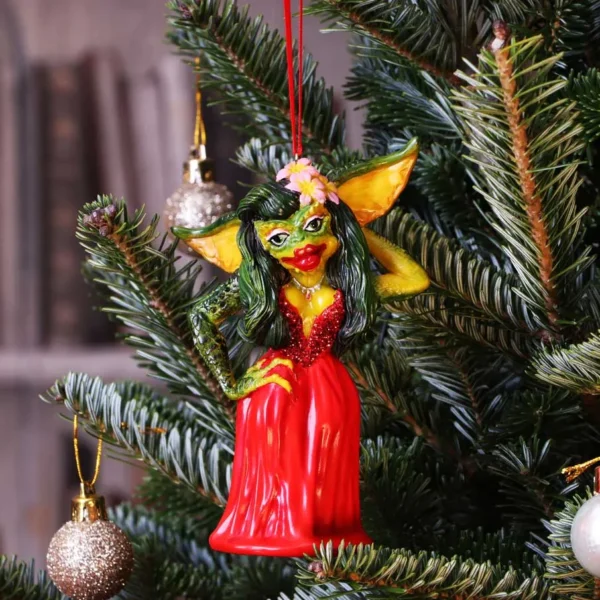 Greta Gremlin Christmas Ornament Red Gown - Festive Tree Décor Greta Gremlin Christmas ornament hanging on a decorated tree with festive lights and baubles. The-Hidden-Hatch