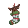 A gremlin Christmas ornament climbing from a green holiday stocking with red ribbon The-Hidden-Hatch