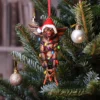 Gremlin Christmas Ornament Resin Figure - Tangled Holiday Lights A Gremlin Christmas ornament tangled in colorful lights on a festive tree. The-Hidden-Hatch