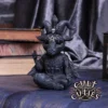 Cult Cuties Gothic Goat Figurine Resin Statue - Black Pentagram Cute gothic goat figurine with horns and pentagram sitting cross-legged among old books and velvet.