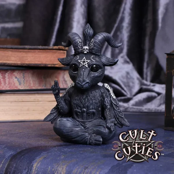 Cult Cuties Gothic Goat Figurine Resin Statue - Black Pentagram Cute gothic goat figurine with horns and pentagram sitting cross-legged among old books and velvet.