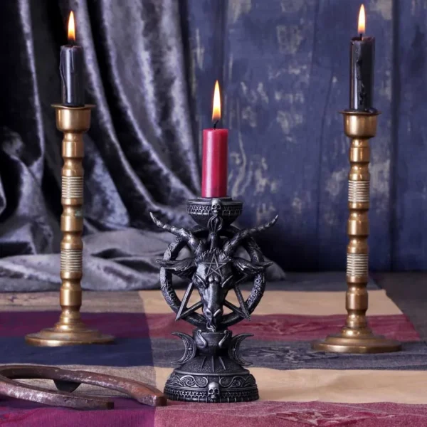 Gothic Wrought Iron Candleholder Red Candle - Occult Decor Gothic candle holders - Three lit candles with gothic and brass holders on patterned cloth with velvet drapery backdrop.