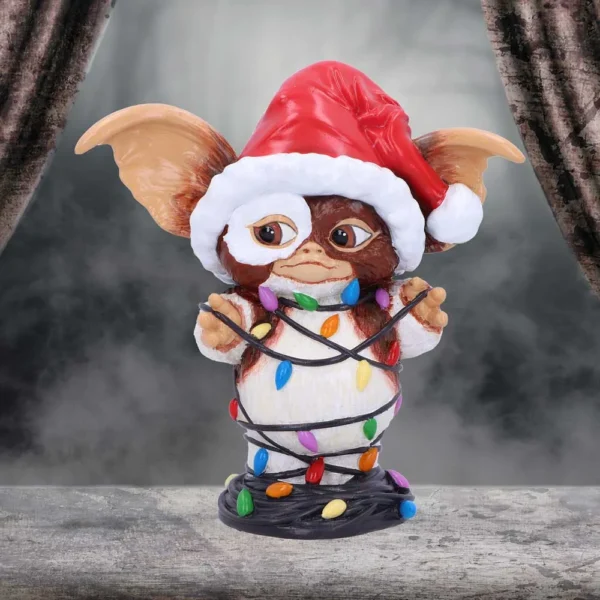 Gizmo Mogwai Figurine Resin Brown Santa Hat With Christmas Lights Gizmo figurine wearing a Santa hat tangled in colorful Christmas lights on display. The-Hidden-Hatch