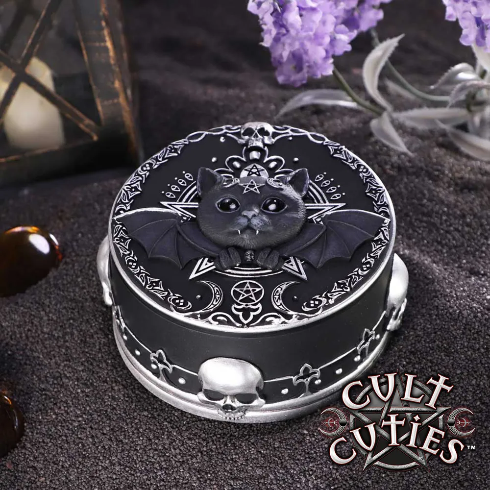 A black gothic cat trinket box with bat wings, silver details, and a candlelit background.