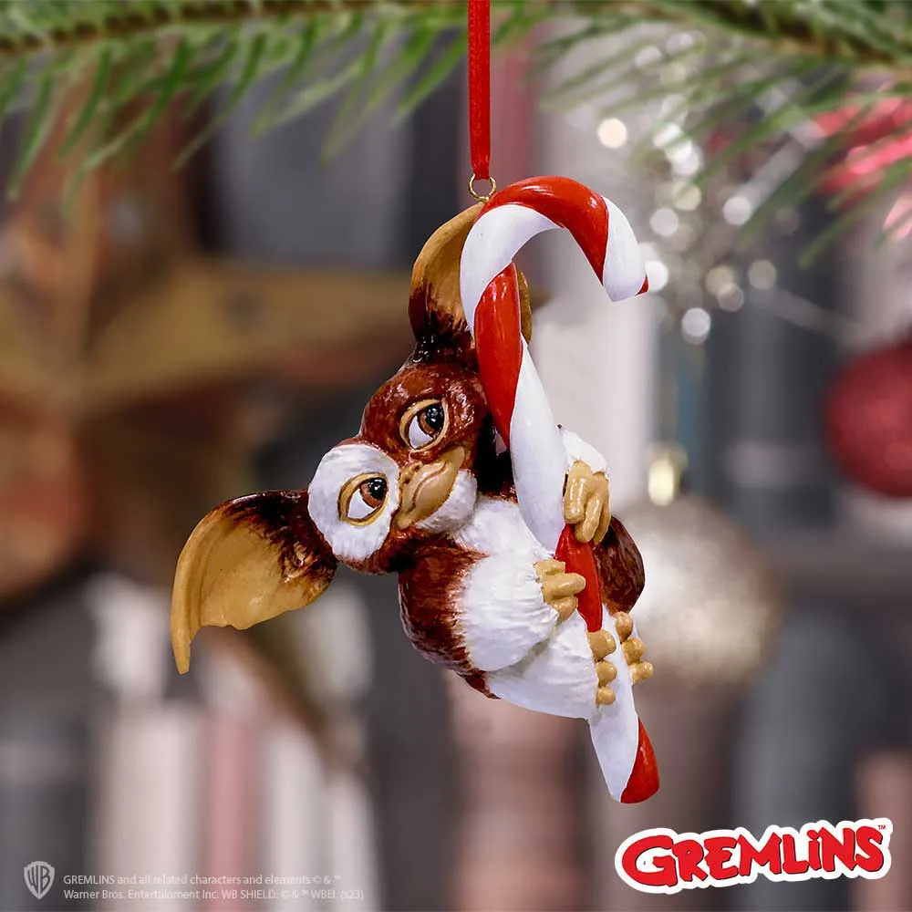 A Smart Guide to Fandom Gift Shopping 3 Fandom Gift Shopping. Gizmo Christmas ornament hugging a red and white candy cane on a tree branch The-Hidden-Hatch