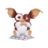 Gizmo Mogwai Collectible Figurine Brown White - 3D Glasses Display Gizmo Mogwai figurine sitting on a striped cushion with 3D glasses in front. The-Hidden-Hatch
