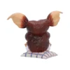 Brown Furry Creature Figurine Resin Sculpture - Large Ears Brown furry creature figurine with large ears sitting on a checkered cushion. The-Hidden-Hatch