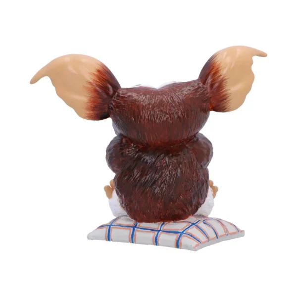 Brown Furry Creature Figurine Resin Sculpture - Large Ears Brown furry creature figurine with large ears sitting on a checkered cushion. The-Hidden-Hatch