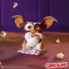 Gizmo Mogwai Collectible Figurine Purple Scene With 3D Glasses Gizmo Mogwai figurine on cushion with 3D glasses and popcorn, purple background The-Hidden-Hatch