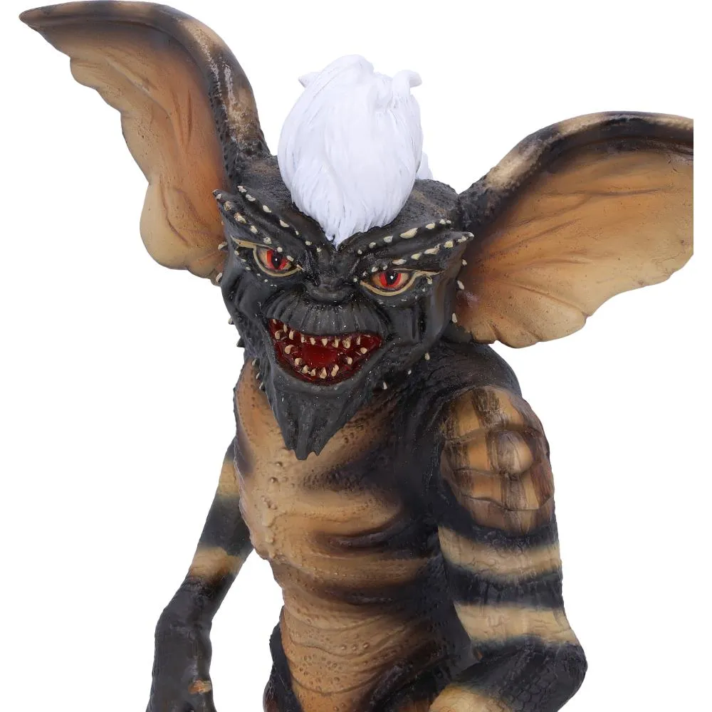 11 Collector Shelf Styling Ideas That Work 8 Collector shelf Close-up of a reptilian, bat-eared gremlin creature with sharp teeth and white mohawk hair The-Hidden-Hatch