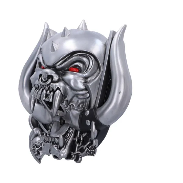 Metal demon head sculpture with glowing red eyes, tusks, and chains. The-Hidden-Hatch