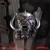 Motörhead Snaggletooth Metallic Sculpture - Red Eyes Chains Metallic Motörhead Snaggletooth sculpture with red eyes and chains on dark wood background The-Hidden-Hatch