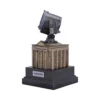 A miniature Bat-Signal model atop the Gotham City Police Department building collectible display.
