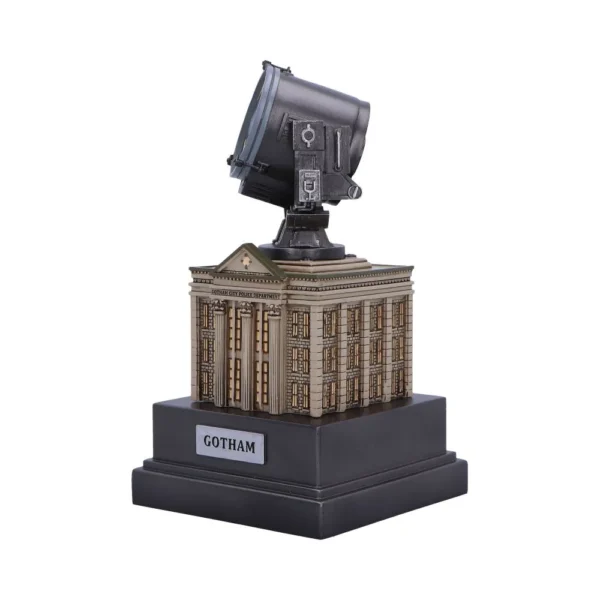 A miniature Bat-Signal model atop the Gotham City Police Department building collectible display.