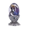 Dragon Egg Ornament Glass Dome Bronze Purple - Celtic Stand A purple and bronze dragon curled inside a transparent decorative egg on an ornate metallic stand.