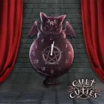 Gothic black cat wall clock with wings and pentagram design against a gray brick background.