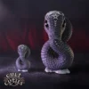 Cult Cuties Serpent Figurines Dark Purple - Mystical Symbols Two dark purple serpent figurines with mystical symbols on their foreheads against a red mist background.