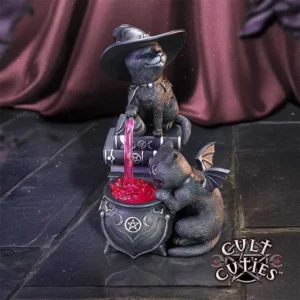 Cult Cuties Black Cat Figurine - Gothic Potion Cauldron Scene Two black cats brewing pink magical potion in a gothic cauldron with spellbooks and occult symbols.
