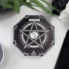 Black Octagonal Electronic Device - White Pentagram Design Black octagonal device with white pentagram design and power button on a white desk.