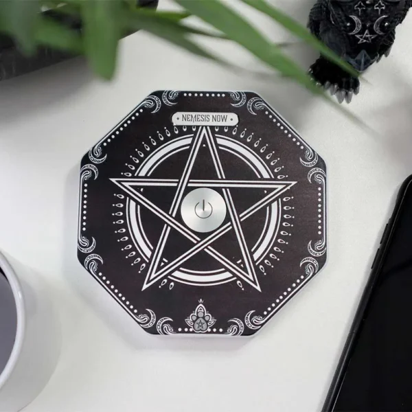 Black Octagonal Electronic Device - White Pentagram Design Black octagonal device with white pentagram design and power button on a white desk.