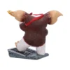 Gizmo Gremlins Figurine Collectible Brown White - Flaming Ear A Gizmo-style Gremlins figurine kneeling on a metal grate with a flaming ear. The-Hidden-Hatch