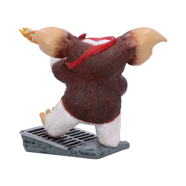 Gizmo Gremlins Figurine Collectible Brown White - Flaming Ear A Gizmo-style Gremlins figurine kneeling on a metal grate with a flaming ear. The-Hidden-Hatch