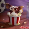 Gizmo Mogwai Collectible Figurine Brown White - Popcorn Bucket Gizmo Mogwai figurine sitting in a red and white popcorn bucket with movie props around. The-Hidden-Hatch