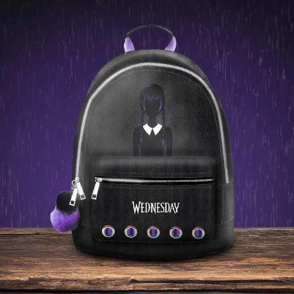 Wednesday Addams Faux Leather Backpack - Black With Purple Trim Black faux leather Wednesday Addams backpack with purple accents on a dark, moody background.